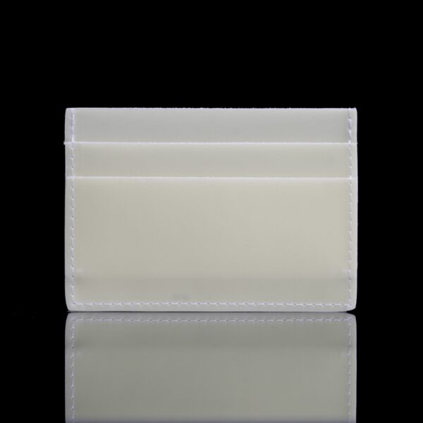 A white plastic card holder sitting on top of a table.