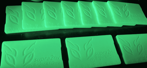 A row of green soap bars with leaves on them.