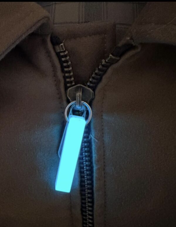 A glowing tag is attached to the zipper.