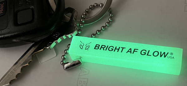 A key chain with the words bright after on it.
