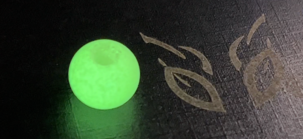 A ball with a glow in the dark logo on it.