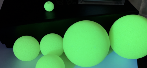 A group of green balls sitting on top of a table.