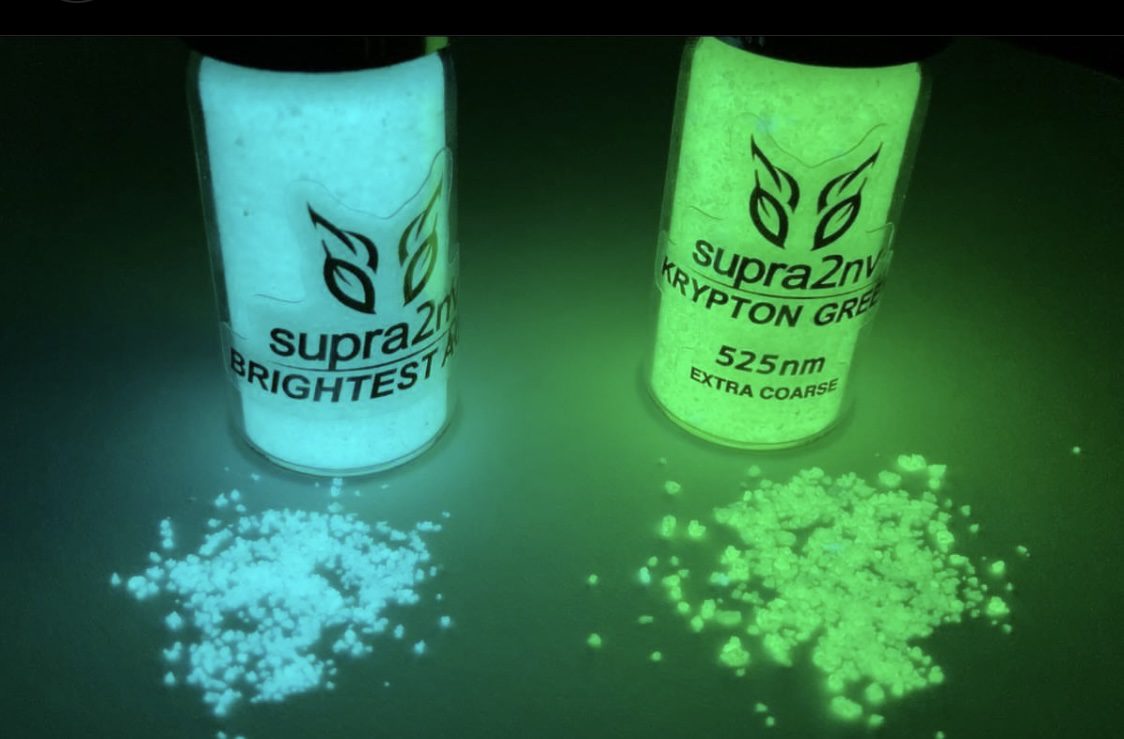 Two cans of glow in the dark substance sitting next to each other.